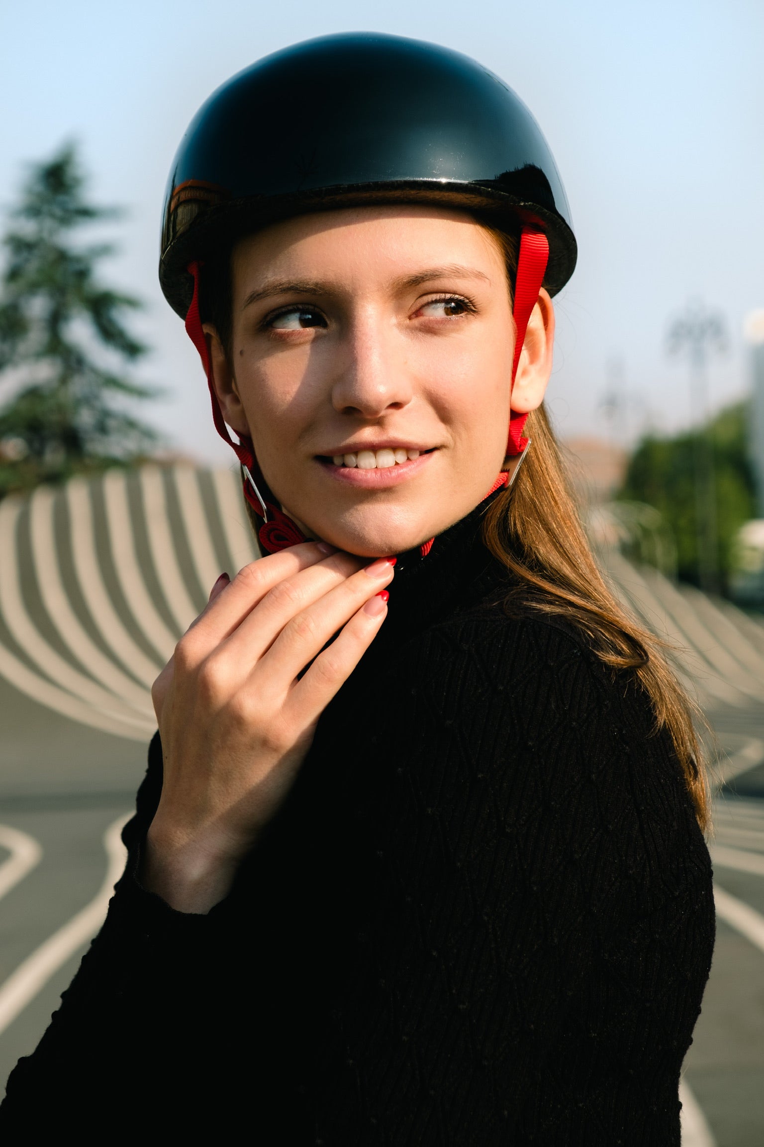 Black YAKKAY skater helmet with Ruby Red straps.